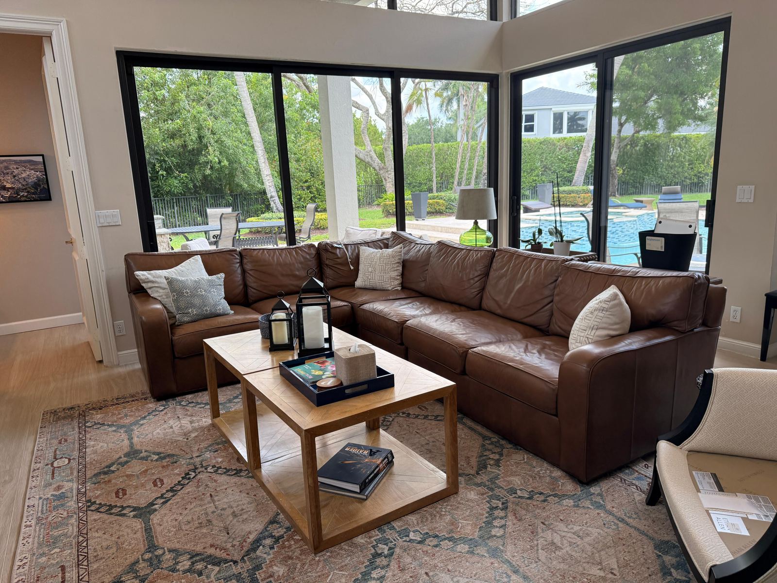 Living room cleaned by Clever Cleaners — leather sectional and patterned rug